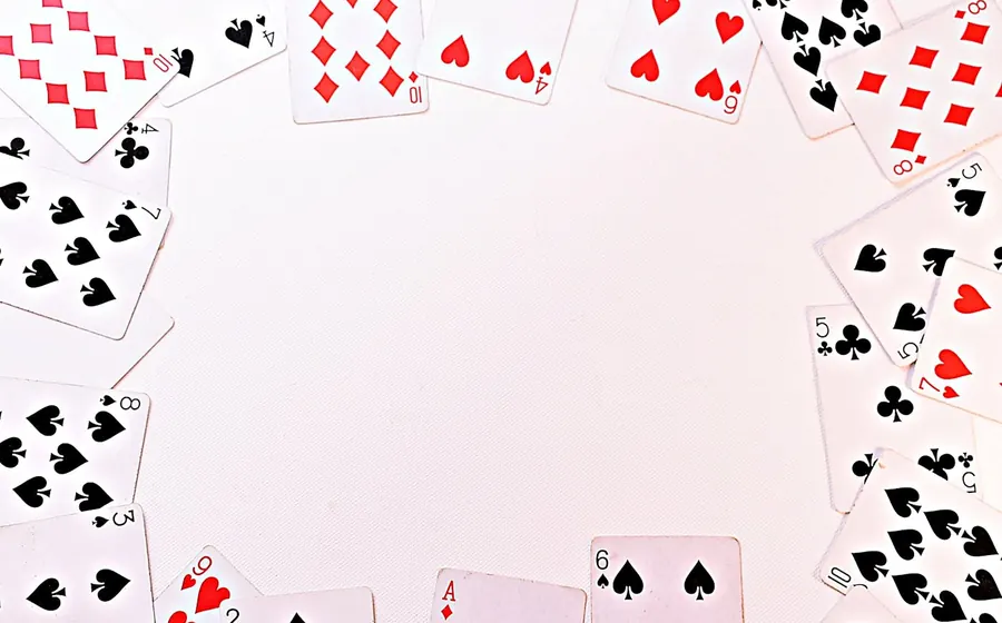 Playing cards spread around a table